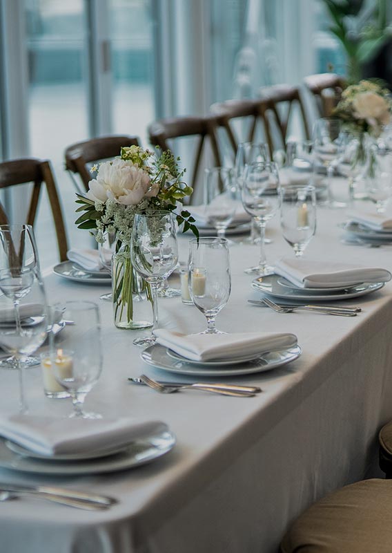 A long table set up for a banquet dinner.