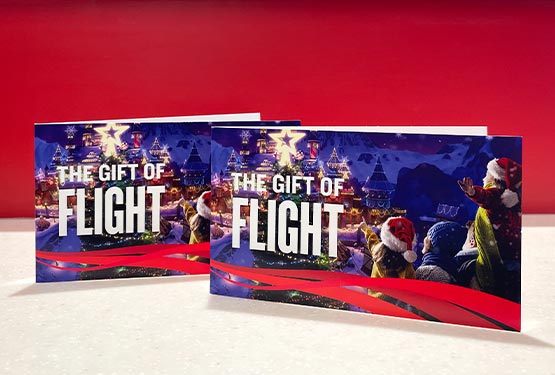 Two gift ticket folders decorated for Christmas, displayed on a table.