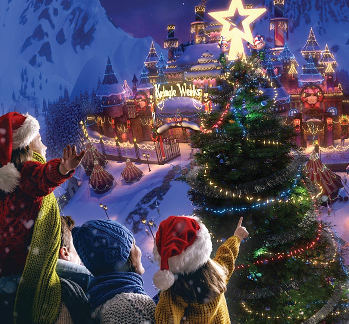 Children point at a Christmas town from the air.