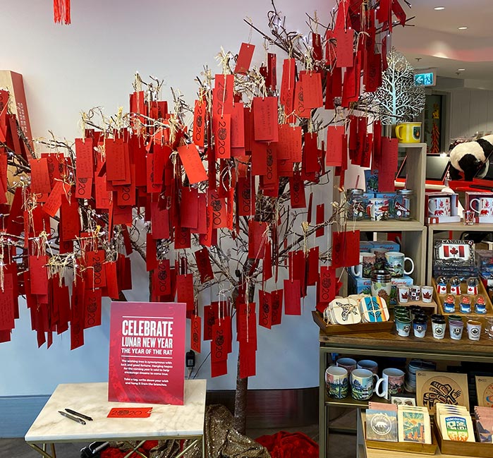 A wishing tree with lots of red tags of messages.