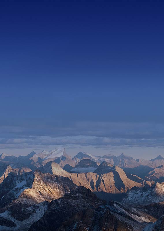 Canadian Rockies mountain range at sunrise, with dark sky