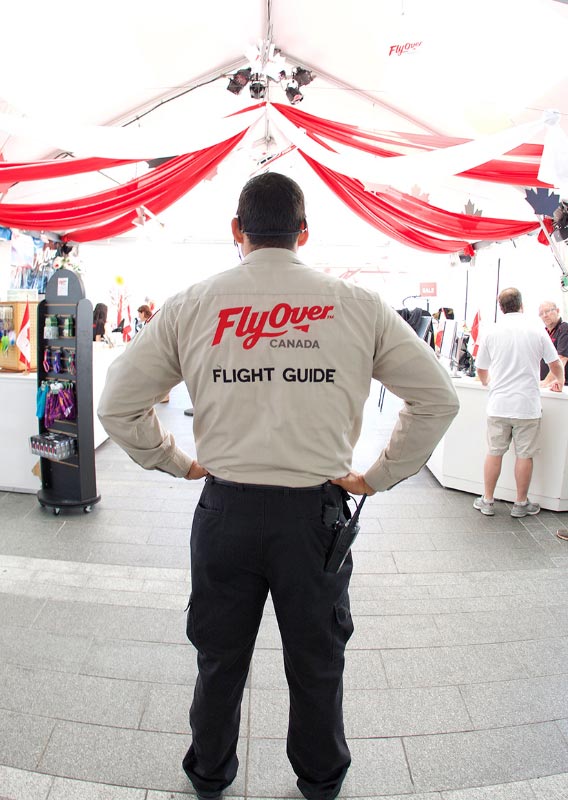 A Flight Guide stands under a white tent.