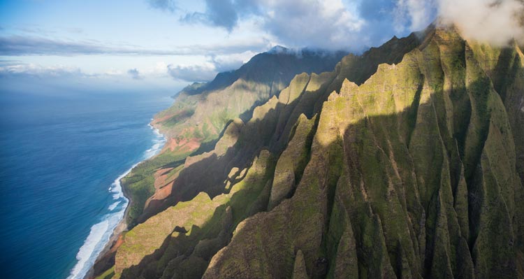 Lush mountainsides above open ocean and beaches.