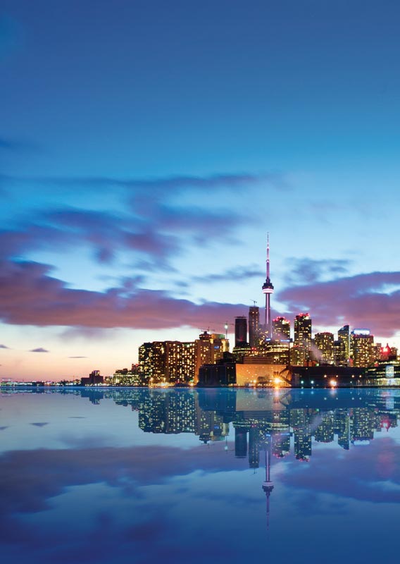 The skyline of Toronto, a city of skyscrapers alongside a lake.
