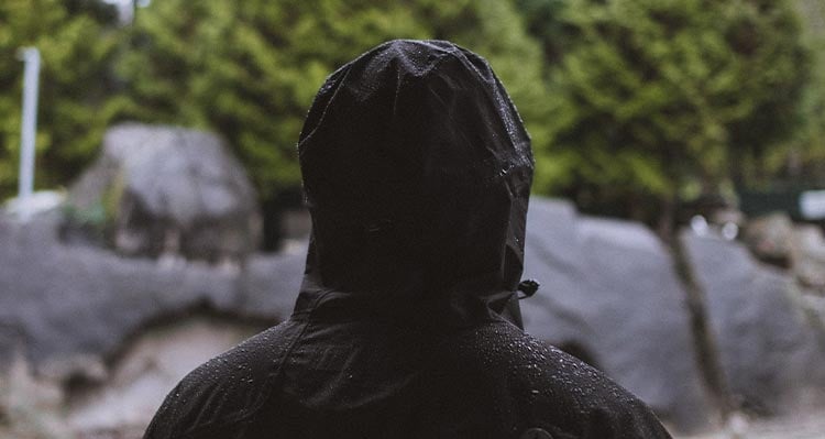 A person in a black rain jacket.