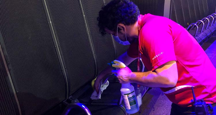 A worker cleans the seats on a flight ride.