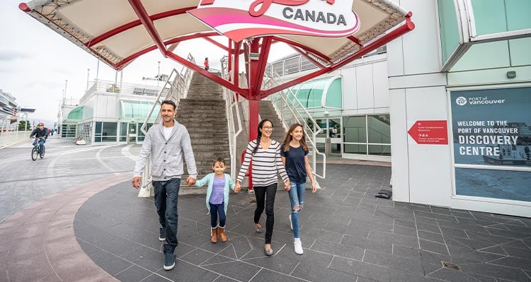 Family exiting the FlyOver Canada entrance, smiling.