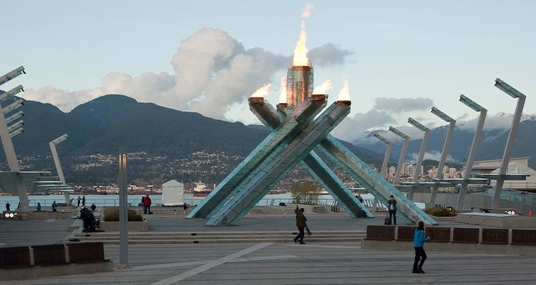 Four columns lean together to form an Olympic Flame sculpture.